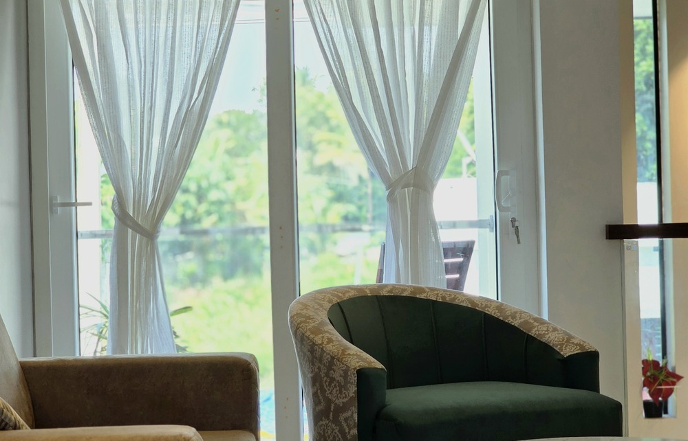 A modern living room interior designed by architects in palakkad, showcasing elegant, functional, and minimalist home decor.