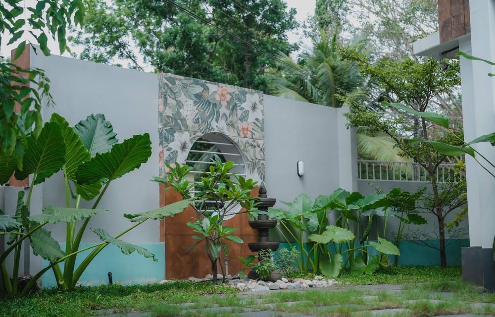 Outdoor landscape design with garden and greenery for a residential property in Kerala